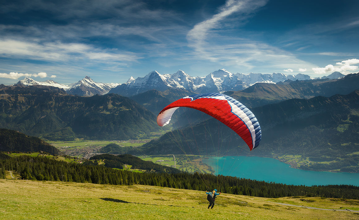 Paraglider taking off in front of spectacular Swiss scenery, Ber
